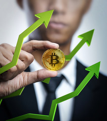 Businessman Holding Bitcoin With Green 3D Arrow up. Bitcoin Price Going Up Concept © natanaelginting