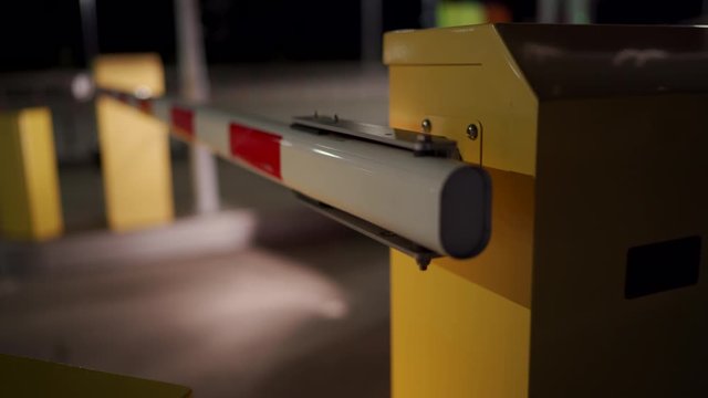 Car auto parking at the airport terminal security system boom barrier gate at night