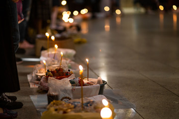 People come to church consecrate Easter cakes and eggs, lit church candles, inserted into the cakes