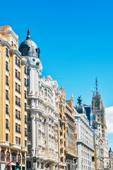 Fototapeta na wymiar Emblematic buildings on the Gran Via in Madrid on a sunny day with a blue sky. Spain. Concept of travel and real estate.