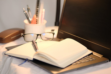 notebook and pen on table background