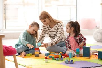 Mother playing with her children at home