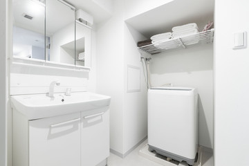 Washbasin and washing machine in the shower at a small apartment