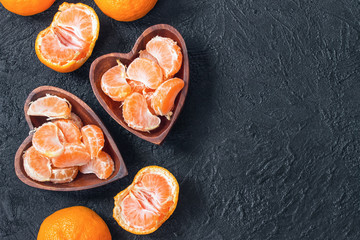 tangerine slices in a wooden bowl top view. background with tangerine slices. tangerines and copy...