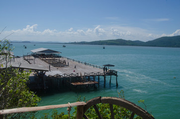 Wide wooden courtyard with fence in blue sea