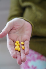 pills in a Senior's hands. Painful old age. Caring for the health of the elderly.