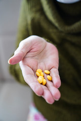 pills in a Senior's hands. Painful old age. Caring for the health of the elderly