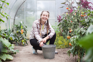 girl working in   greenhouse