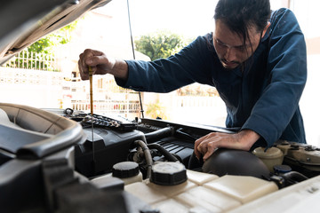 Professional mechanic providing car repair and maintenance service in auto garage. Car service...