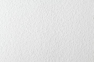 Uniform white roughly textured wall 