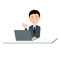 ノートパソコンを使用しながらOKサインをする若い男性会社員