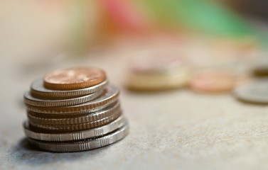 The close-up group of a Thai coins placed on the floor selective focus and shallow depth of field.