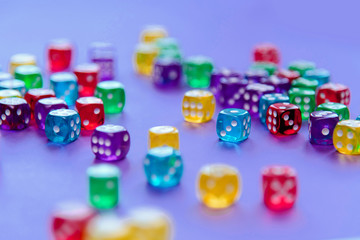 Colorful dice set on violet background