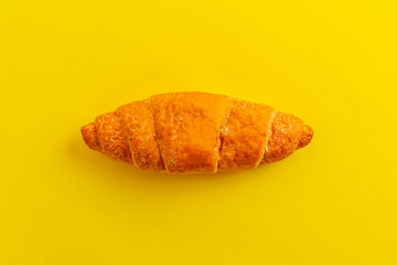 a simple croissant  isolated against the colrful background, traditional french food, minimalism concept
