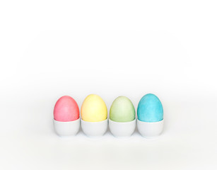 Colorful Easter eggs in stands on a white background. Easter concept. Copy space