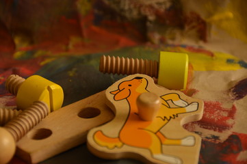 wooden toys on coloured painted paper