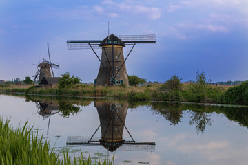 A windmill by a canal in Kinderdijk in the Netherlands