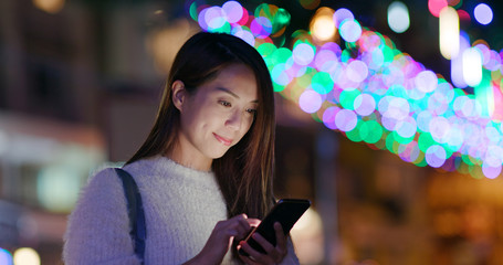 Woman use smart phone at night