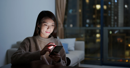 Woman watch on cellphone at home