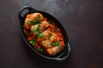 Cabbage rolls stuffed with ground beef and rice in tomato sauce