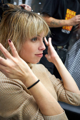 Fototapeta premium Hairdresser dries hair to client with hand dryer.