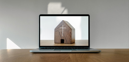 Worship from home, Online live church for sunday service, Laptop screen with wooden cross church photo on wooden table