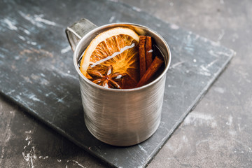 Apple cider in metal mug on the rustic background. Selective focus. Shallow depth of field.