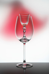 
Two glass goblets on color gradient background
