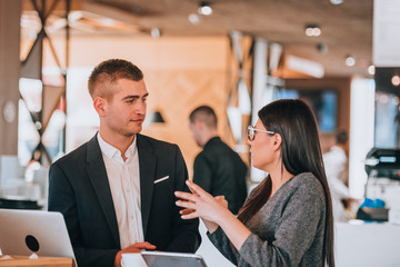 Coffee break conversation with lap top and tablet