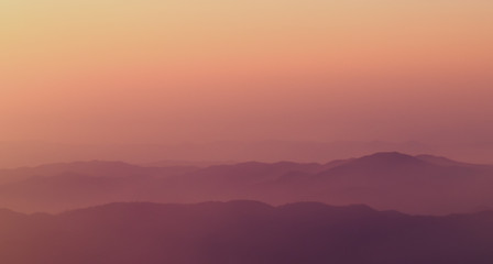 Low clouds in mountains, sunset light