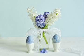 Easter decorations with painted eggs with Hyacinth on pastel color background, Spring greeting card. copy space.