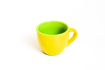 Little empty ceramic yellow and green coffee mug , coffee cup isolated on white background