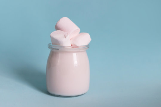 Pink Yogurt With Marshmallows On A Blue Background