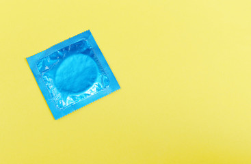 Condom isolated on yellow background - Colorful condom pack for birth control contraceptive means prevent pregnancy or sexually transmitted disease