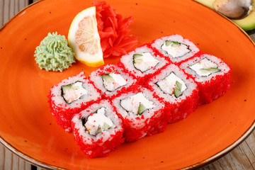 Rolls, wasabi, soy sauce, ginger on the table, avocado.