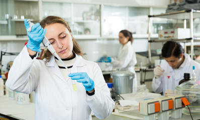 Female student mixing chemicals