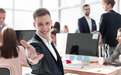 friendly young businessman sitting at his Desk