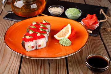 Rolls, wasabi, soy sauce, ginger on the table, avocado.