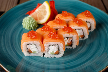 Rolls, wasabi, soy sauce, ginger on the table, avocado.