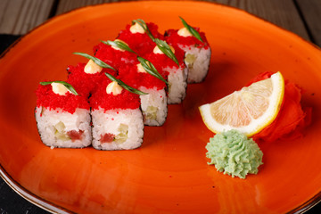 Rolls, wasabi, soy sauce, ginger on the table, avocado.