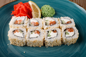 Rolls, wasabi, soy sauce, ginger on the table, avocado.