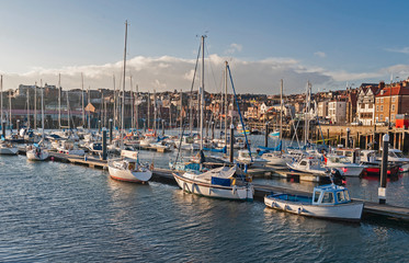 Fototapeta na wymiar Marina in seaside town with sailing yachts