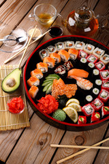 large colorful set of sushi in a round plate.