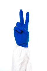 Obraz premium Doctor's or nurses hands in navy gloves making peace sign with hands isolated on white background