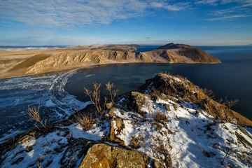 Coast of lake Baikal in December with rocks on a sunny frosty day