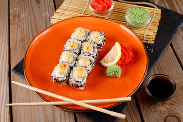 Baked sushi, rolls sprinkled with sesame seeds