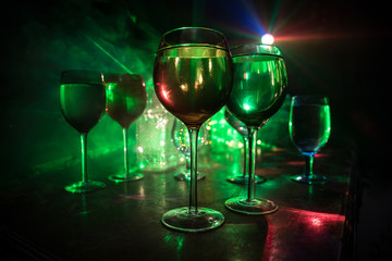Goblet of white wine on wooden table on wooden wall background