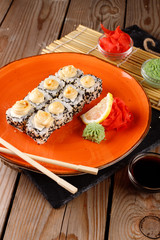 Baked sushi, rolls sprinkled with sesame seeds
