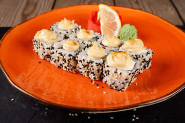 Baked sushi, rolls sprinkled with sesame seeds