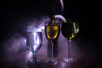 Goblet of white wine on wooden table on wooden wall background
